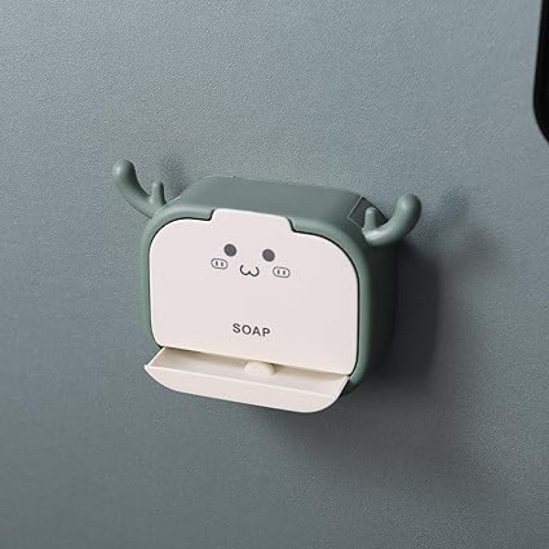 Wall-mounted soap dispenser with cartoon design on a gray wall