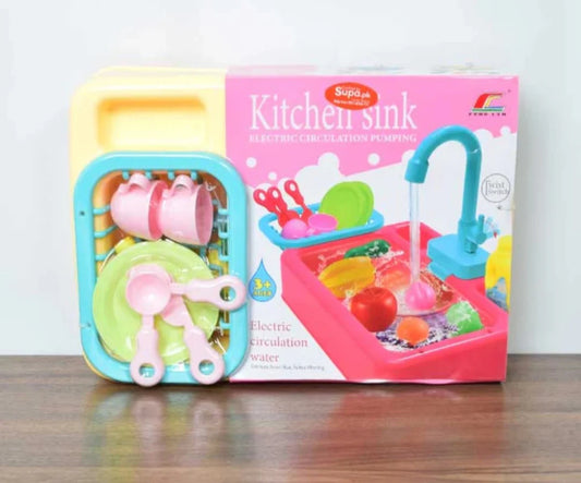 Toy kitchen sink set with packaging on a wooden surface