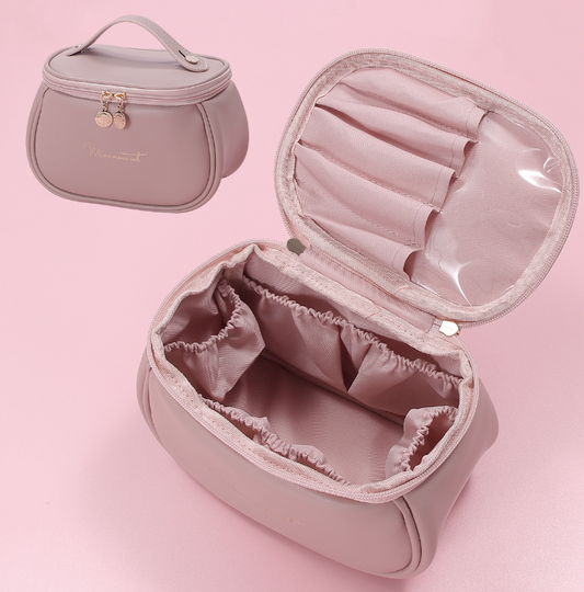 Pink makeup bag with a smaller matching bag on a pink background
