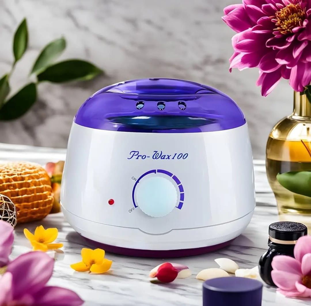 White and purple wax warmer with floral and decorative items on a table